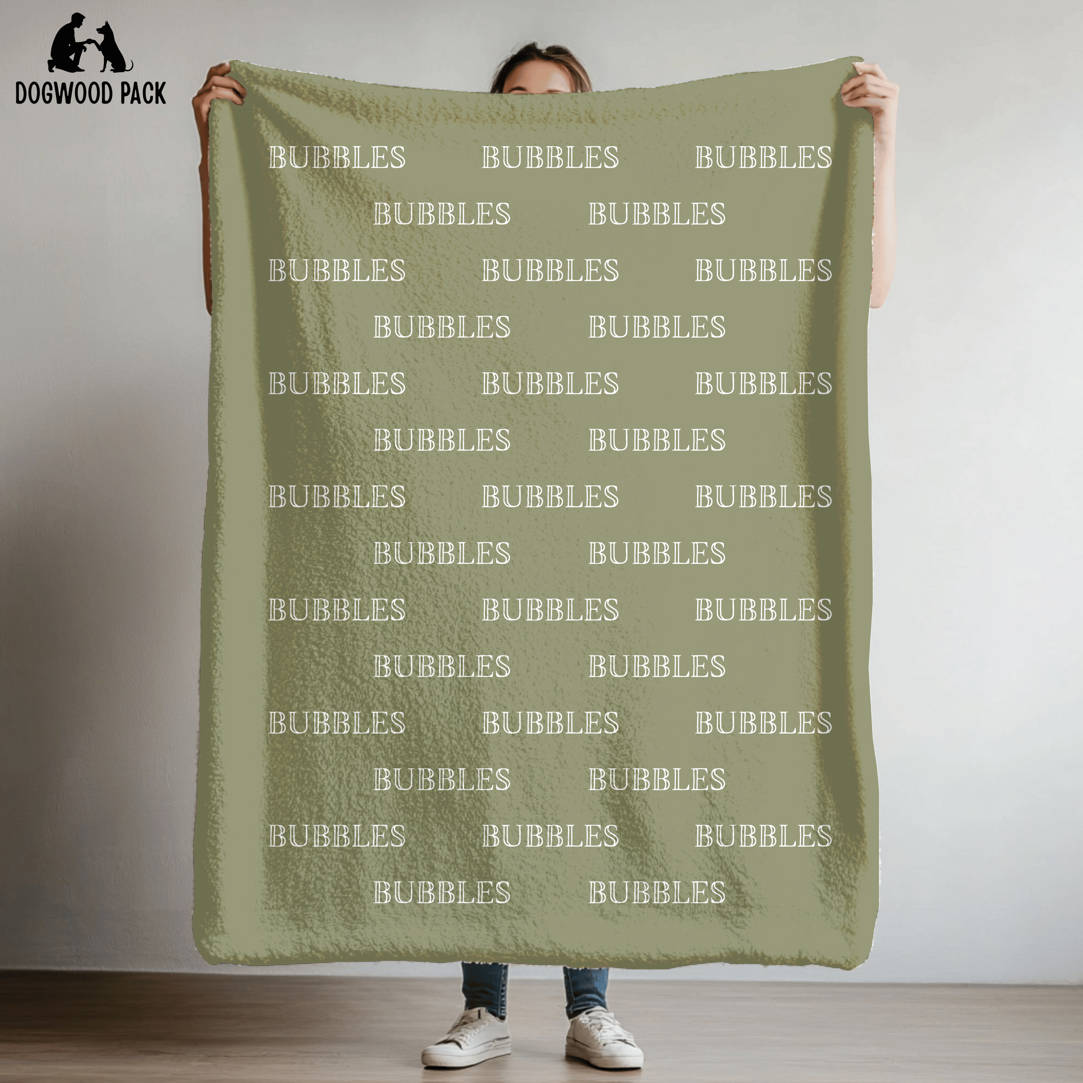 custom dog blanket that is personalized with bubble name in plush and sherpa fabric on green background