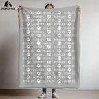 custom dog blanket that is personalized with name and paw print design in plush and sherpa fabric on light grey background