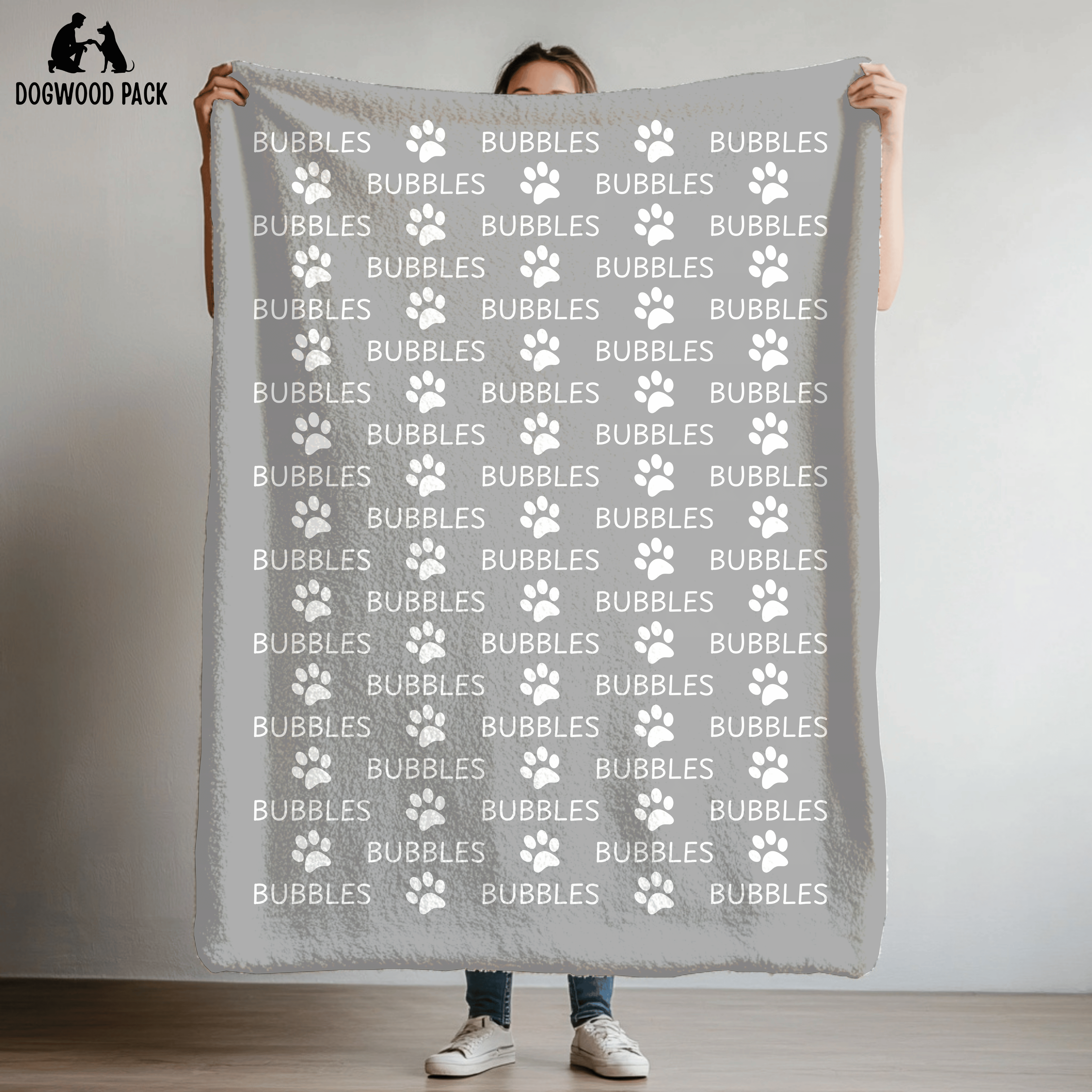 custom dog blanket that is personalized with name and paw print design in plush and sherpa fabric on light grey background