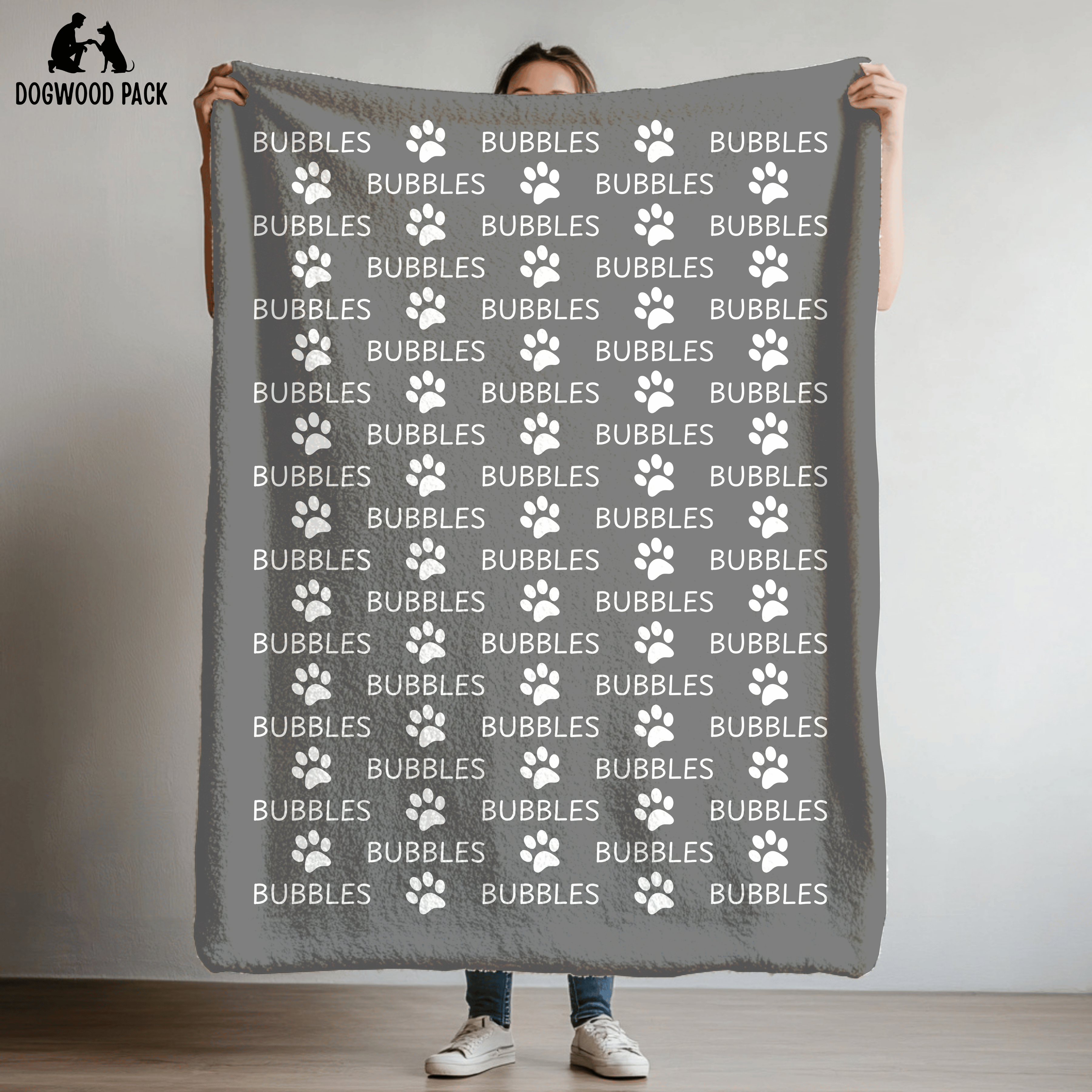 custom dog blanket that is personalized with name and paw print design in plush and sherpa fabric on grey background