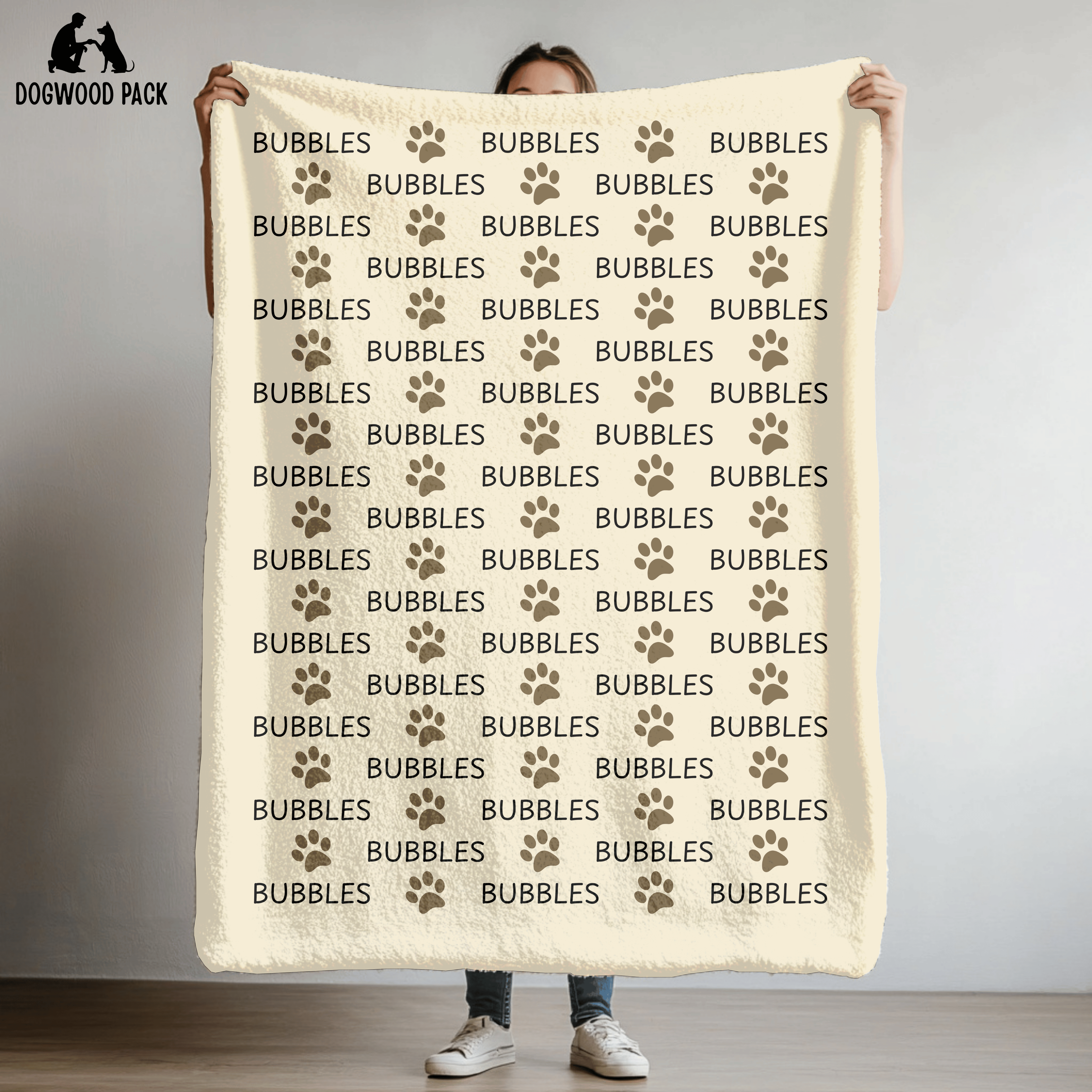 custom dog blanket that is personalized with name and paw print design in plush and sherpa fabric on beige background