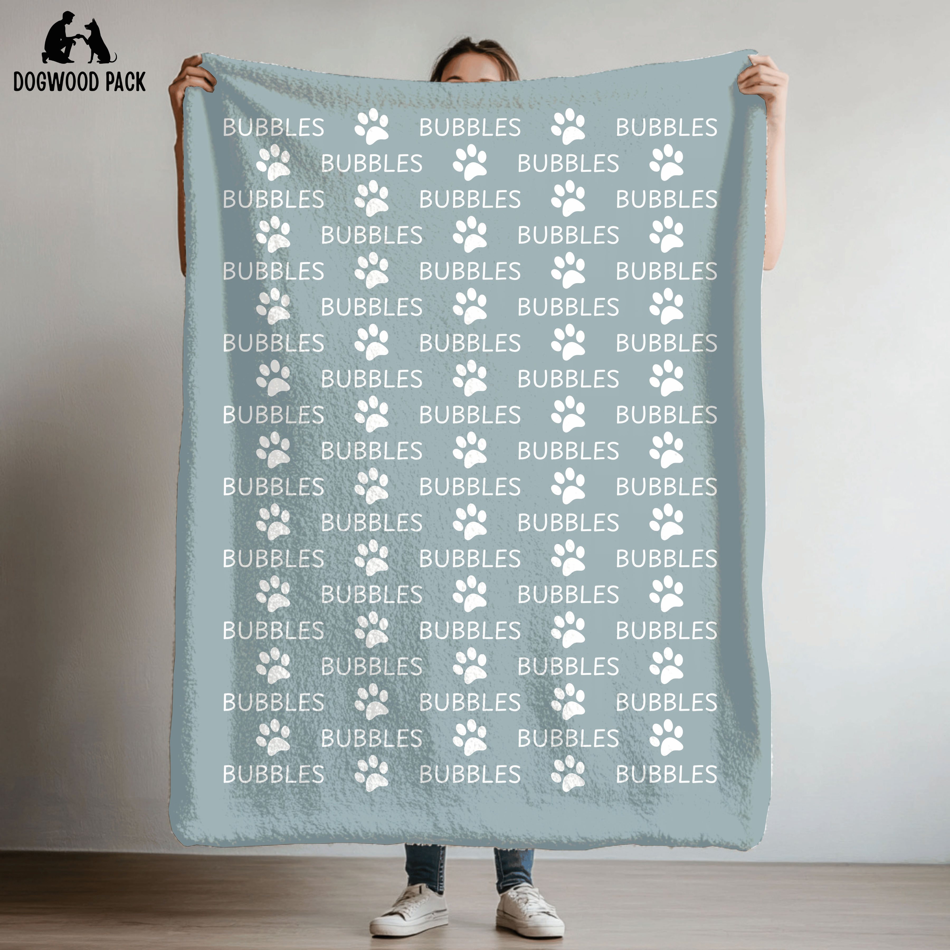 custom dog blanket that is personalized with name and paw print design in plush and sherpa fabric on blue background