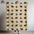 dog blanket with bear paw design on a tan background in plush and sherpa fabrics