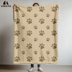 dog blanket with paw print design on a tan background in plush and sherpa fabrics