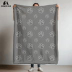 dog blanket with wolf paw design on a grey background in plush and sherpa fabrics